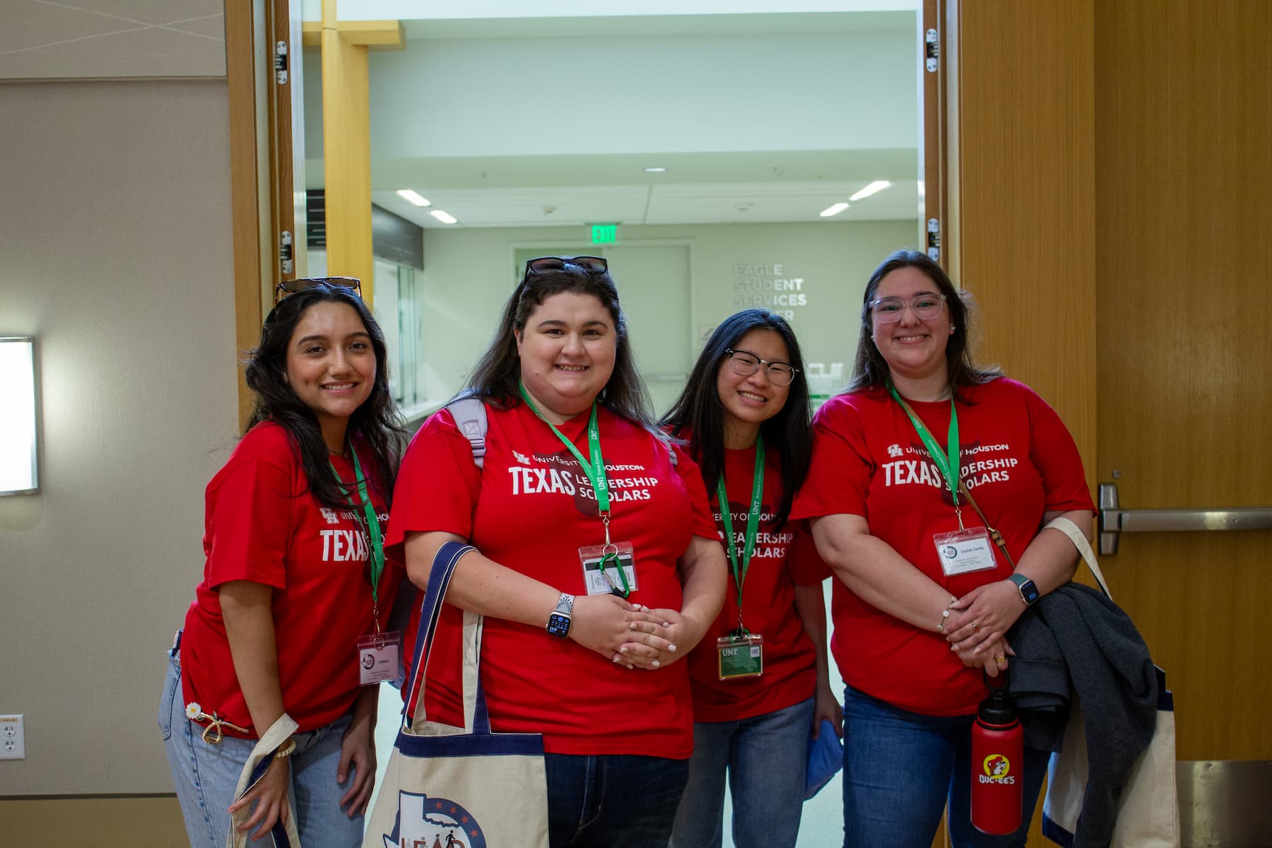 University of Houston campus coordinator and students standing together