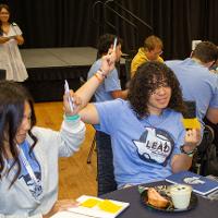 two people at table 11 raising their hands