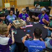 Group of 9 people talking around a black table