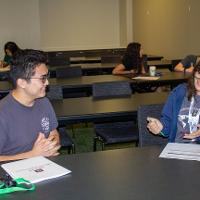 Two people talking at a table