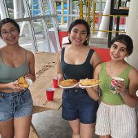 Group of 5 holding food and smiling