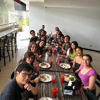 Group photo of everyone eating at a table.
